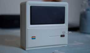 Ayaneo Retro Mini PC AM01 face up on a table, with a candle in the background
