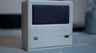 Ayaneo Retro Mini PC AM01 face up on a table, with a candle in the background