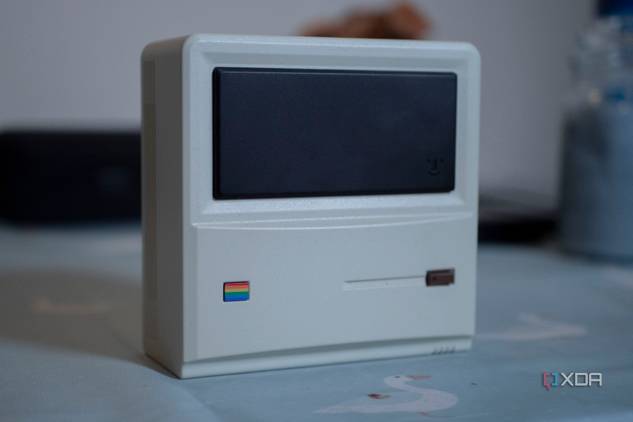 Ayaneo Retro Mini PC AM01 face up on a table, with a candle in the background