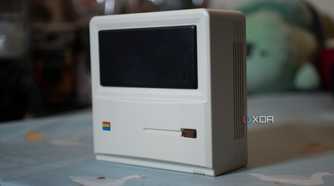 The front and side of the Ayaneo AM01 Retro Mini PC, standing upright on a table