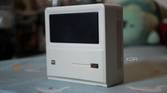The front and side of the Ayaneo AM01 Retro Mini PC, standing upright on a table