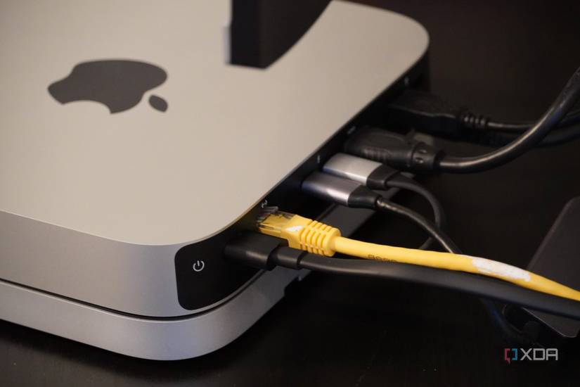 Cables coming out of the back of a Mac Mini.