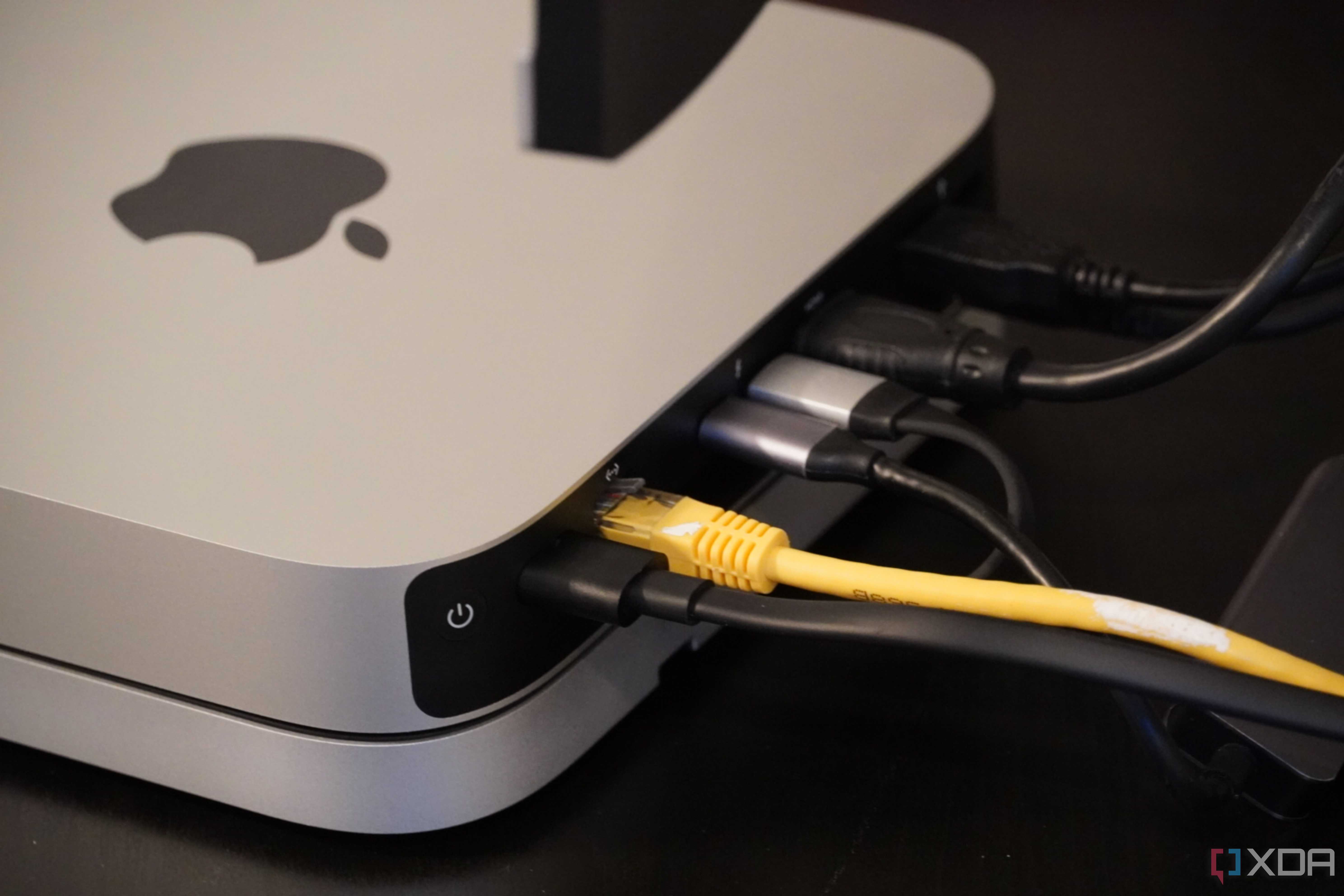 Cables coming out of the back of a Mac Mini.