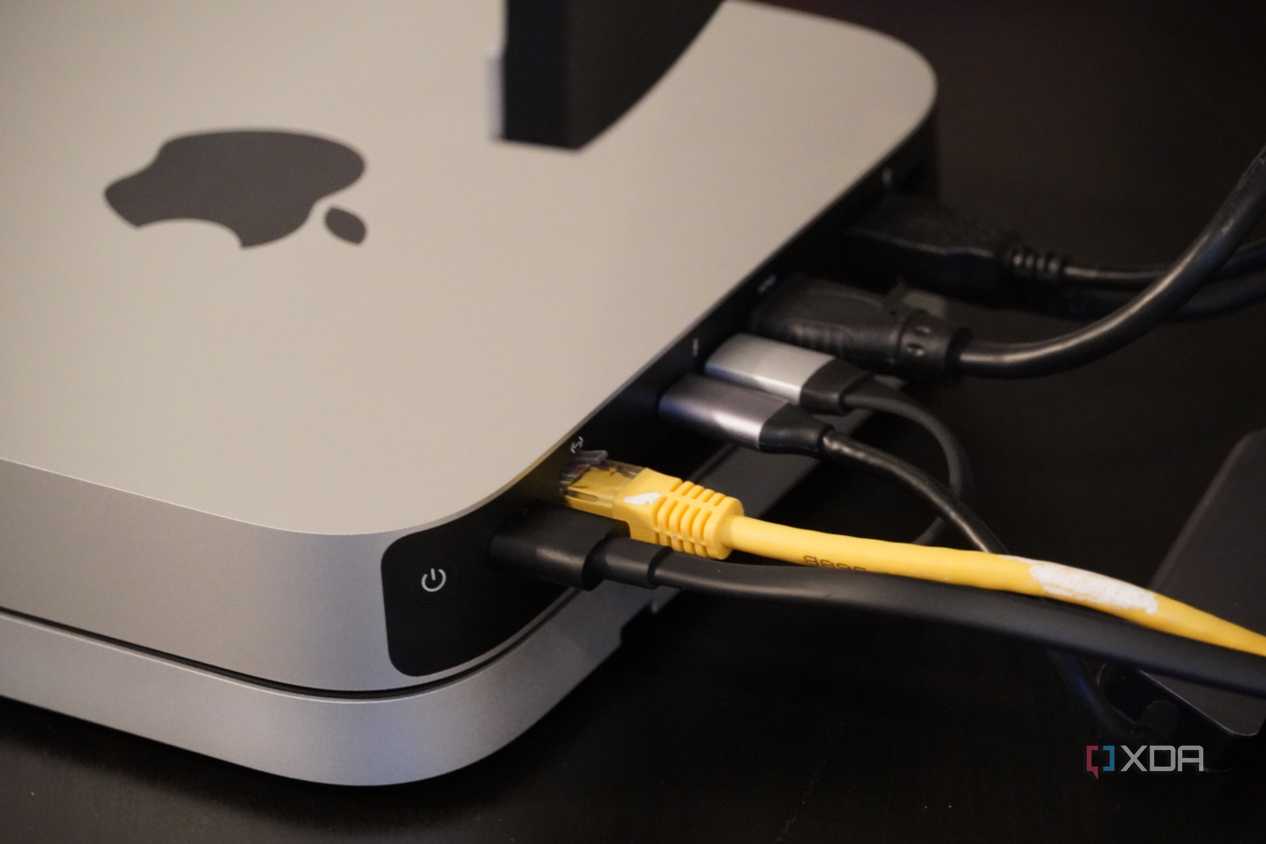 Cables coming out of the back of a Mac Mini.