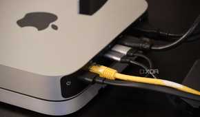 Cables coming out of the back of a Mac Mini.