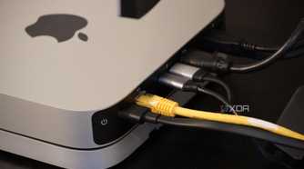 Cables coming out of the back of a Mac Mini.