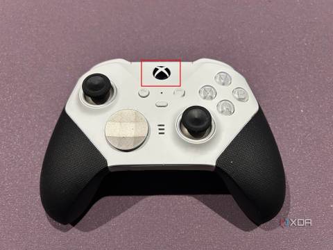 Xbox controller on a purple background with the power button highlighted.