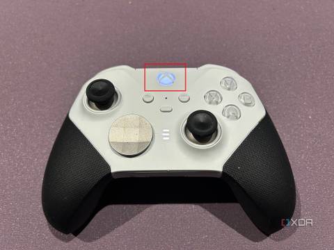 Xbox controller on a purple background with the power button highlighted and on.