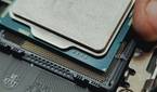 An image showing a person installing the processor on a motherboard.