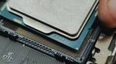 An image showing a person installing the processor on a motherboard.
