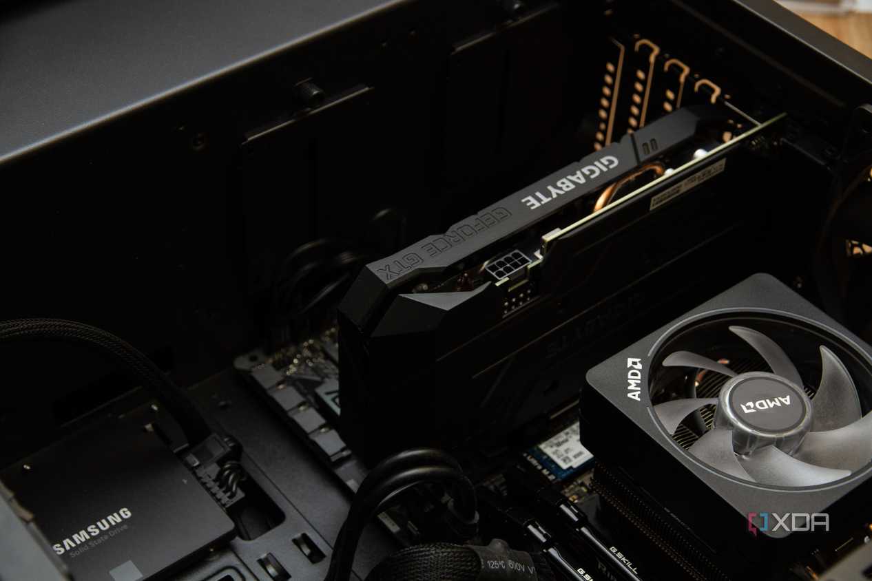 An open pc case, with a Gigabyte graphics card installed next to an AMD CPU heatsink and a Samsung SSD.