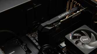 An open pc case, with a Gigabyte graphics card installed next to an AMD CPU heatsink and a Samsung SSD.