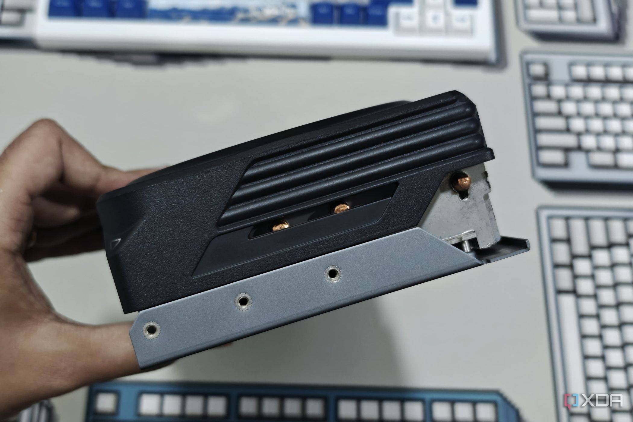 An image showing a person holding the Gigabyte GeForce RTX 4070 Ti Gaming OC GPU to show its side profile.
