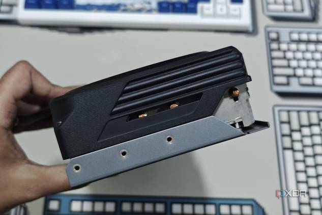 An image showing a person holding the Gigabyte GeForce RTX 4070 Ti Gaming OC GPU to show its side profile.