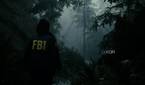 A screenshot showing "god rays" peeking through the trees in Alan Wake 2.