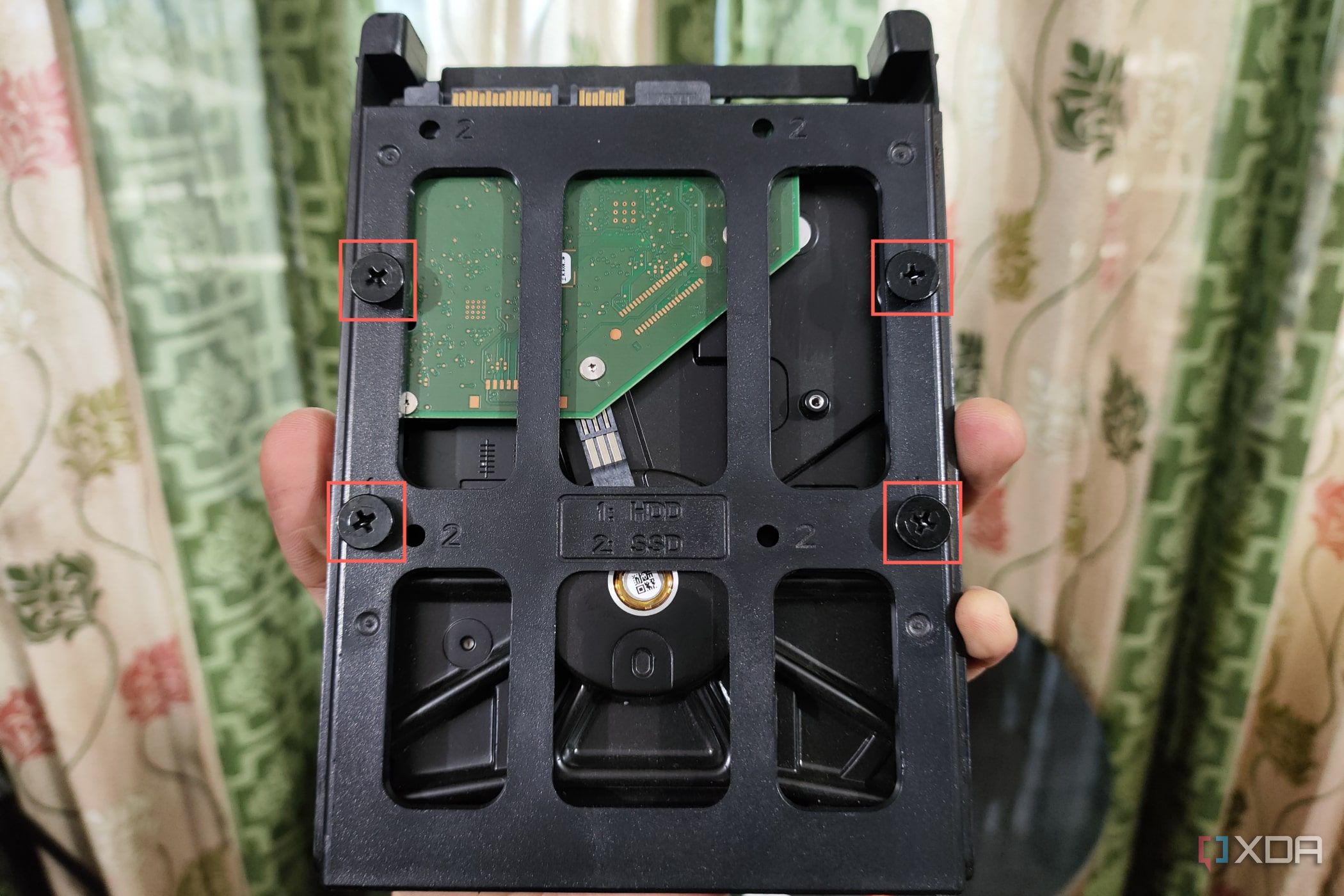 An image of a hard drive slotted into a mounting bracket