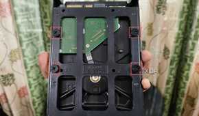 An image of a hard drive slotted into a mounting bracket