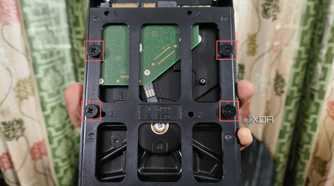 An image of a hard drive slotted into a mounting bracket