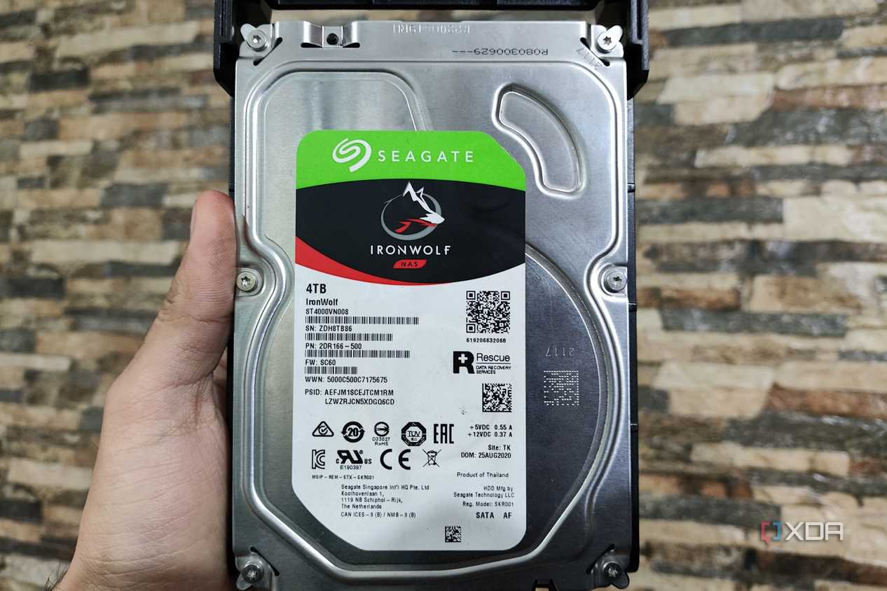 A person holding a Seagate IronWolf NAS HDD