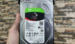 A person holding a Seagate IronWolf NAS HDD