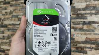 A person holding a Seagate IronWolf NAS HDD