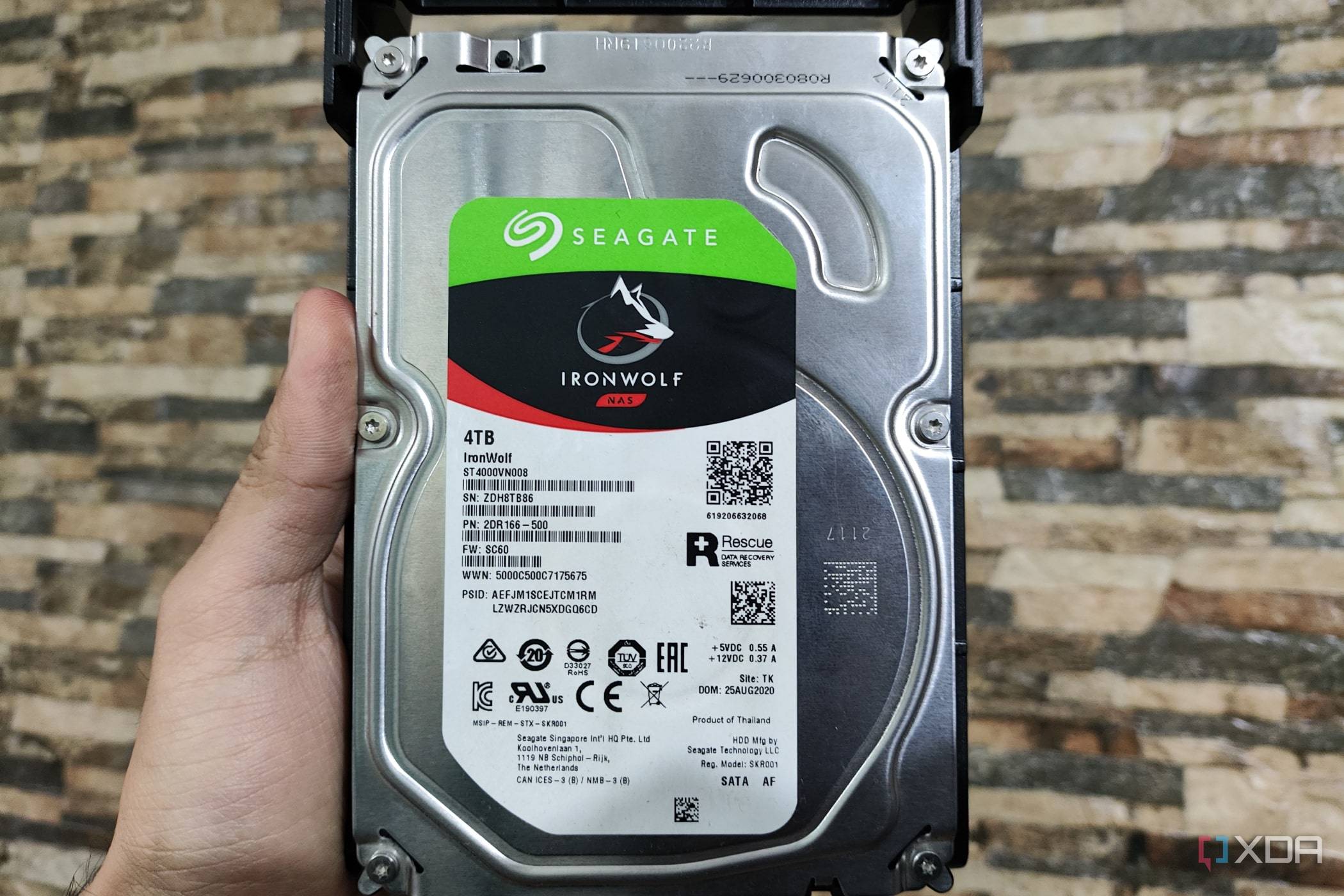 A person holding a Seagate IronWolf NAS HDD