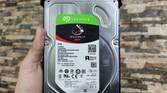 A person holding a Seagate IronWolf NAS HDD