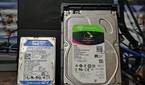 A Seagate IronWolf NAS 4TB hard drive kept next to a WD Blue 500GB hard drive