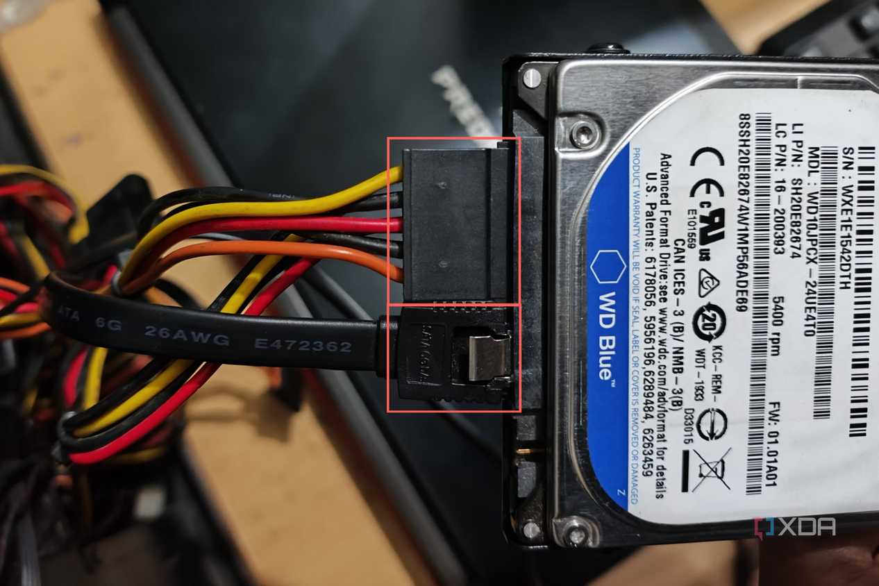 An image of SATA data and power cables plugged into a WD 500GB HDD