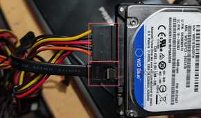 An image of SATA data and power cables plugged into a WD 500GB HDD