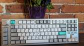 A Lemokey L3 stood up in front of a brick wall and a vase