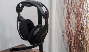 A photo of the Logitech G Astro 50 X Lightspeed sitting on a holder with a plant in the background