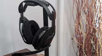 A photo of the Logitech G Astro 50 X Lightspeed sitting on a holder with a plant in the background