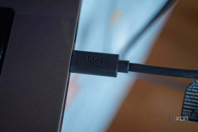 Logitech StreaCam USB-C connector plugged into a laptop, with "Logi" inscribed in it
