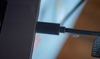 Logitech StreaCam USB-C connector plugged into a laptop, with "Logi" inscribed in it