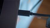 Logitech StreaCam USB-C connector plugged into a laptop, with "Logi" inscribed in it