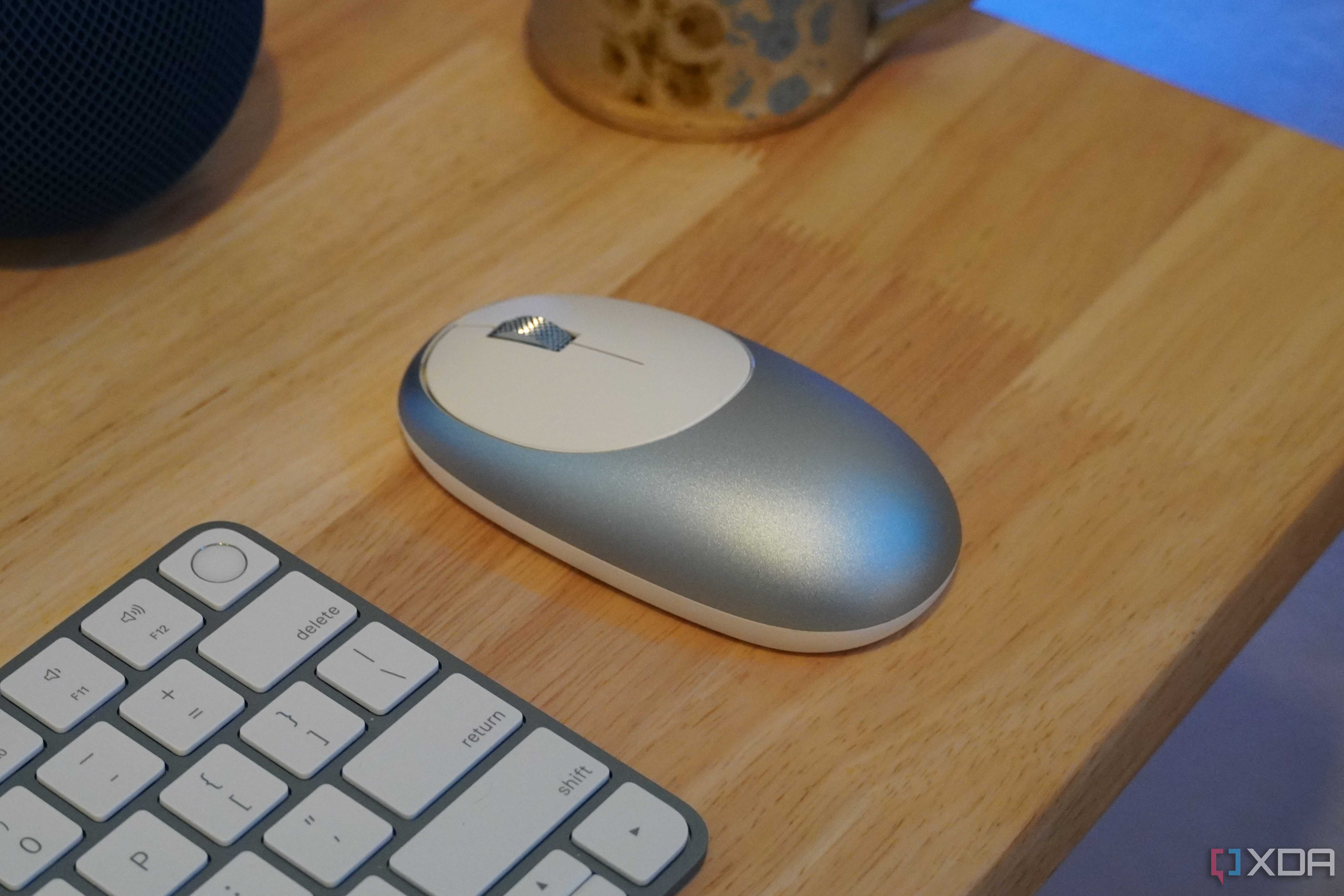 An M1 mouse as part of a desk setup.