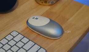 An M1 mouse as part of a desk setup.