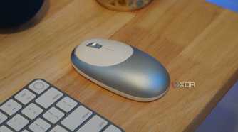 An M1 mouse as part of a desk setup.