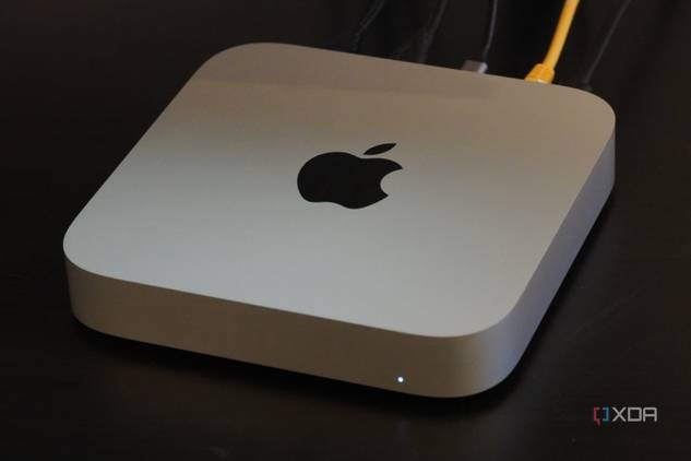 A Mac Mini on a desk with cables connected.