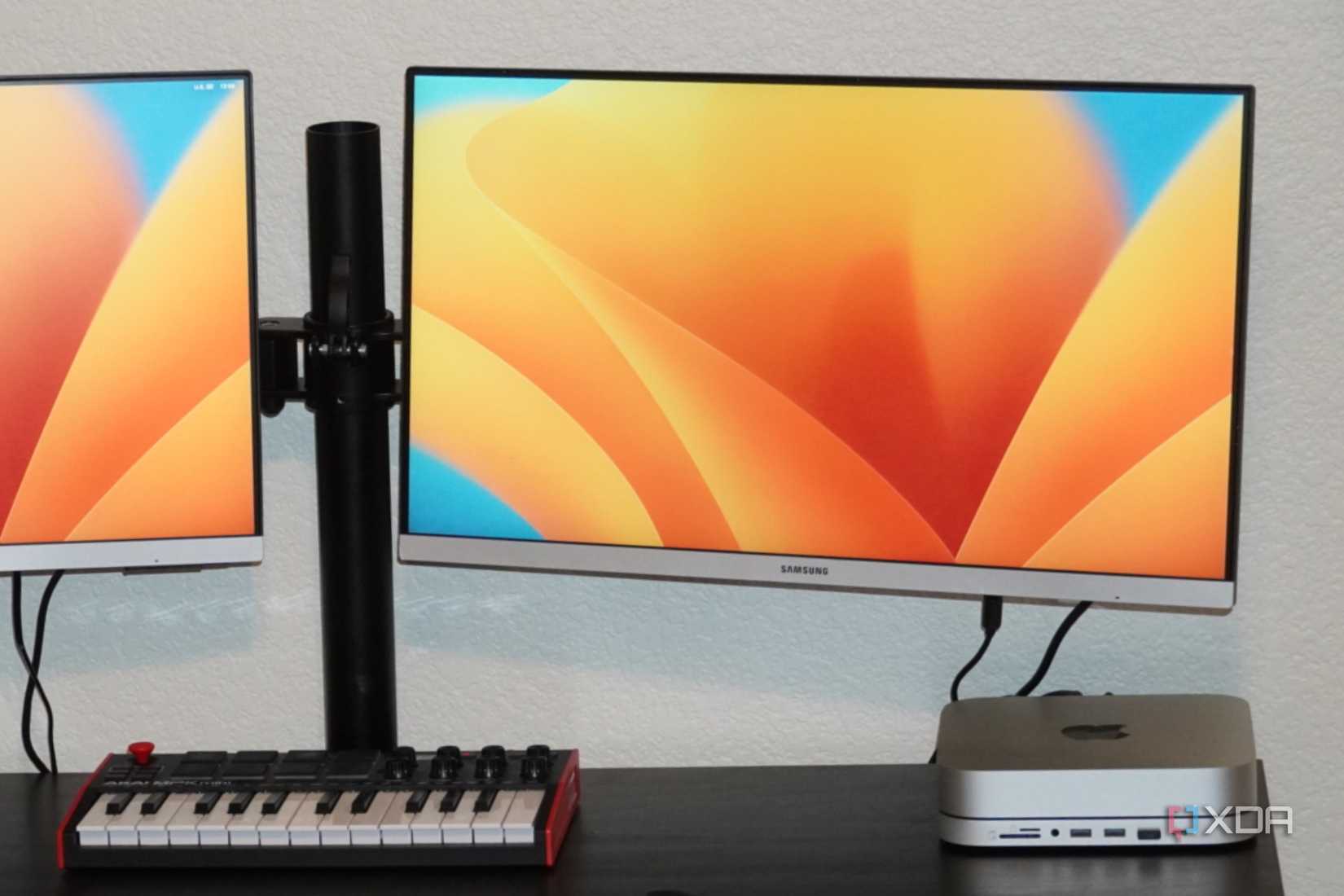The Mac Mini on a desk with two monitors connected. 