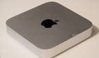 The silver Mac Mini on a desk.