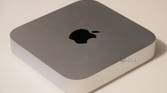 The silver Mac Mini on a desk.