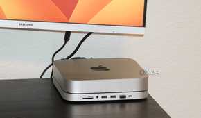 A Mac Mini with a macOS wallpaper in the background.