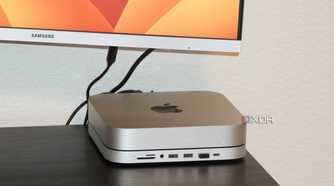 A Mac Mini with a macOS wallpaper in the background.