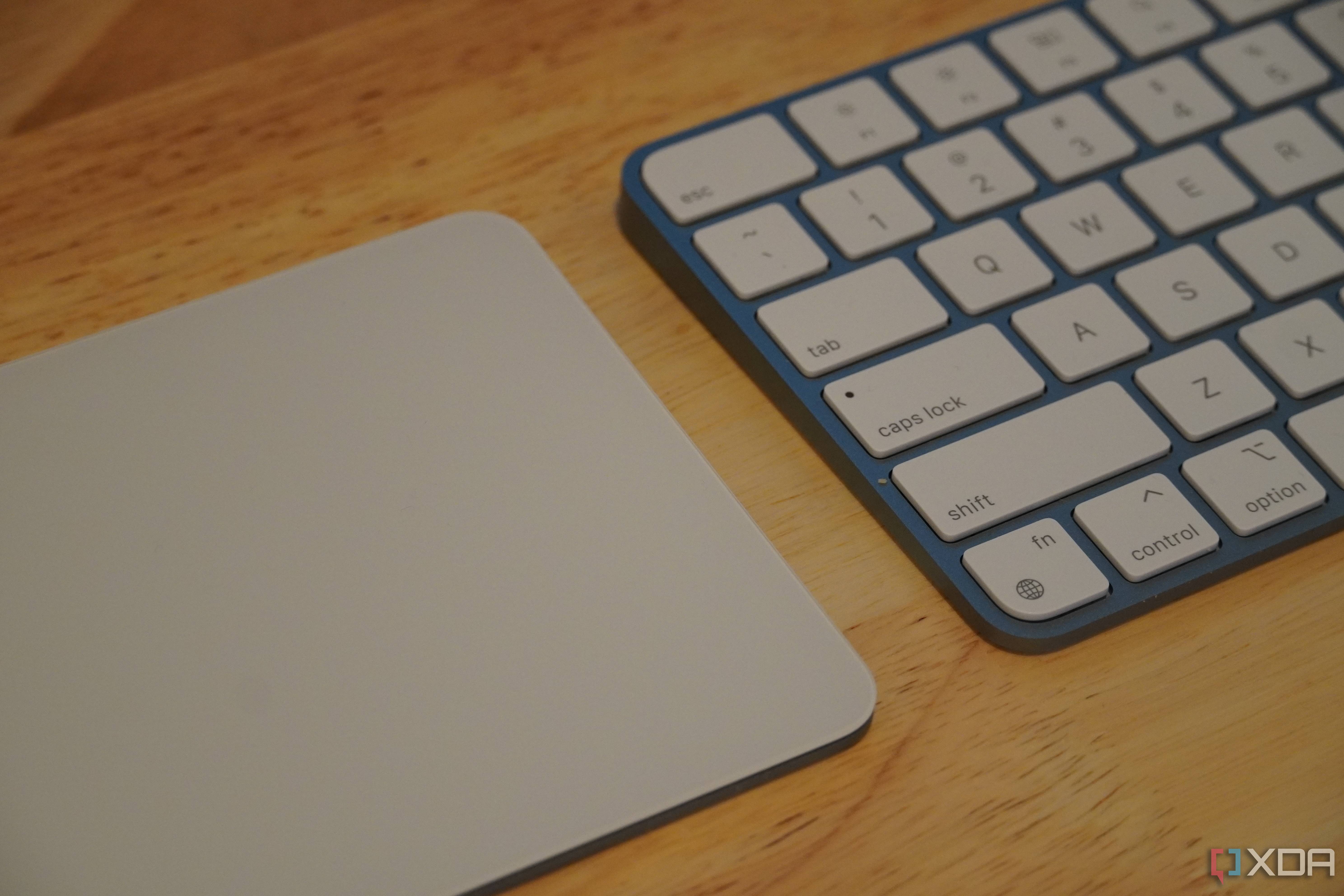 A Magic Trackpad beside a Magic Keyboard.