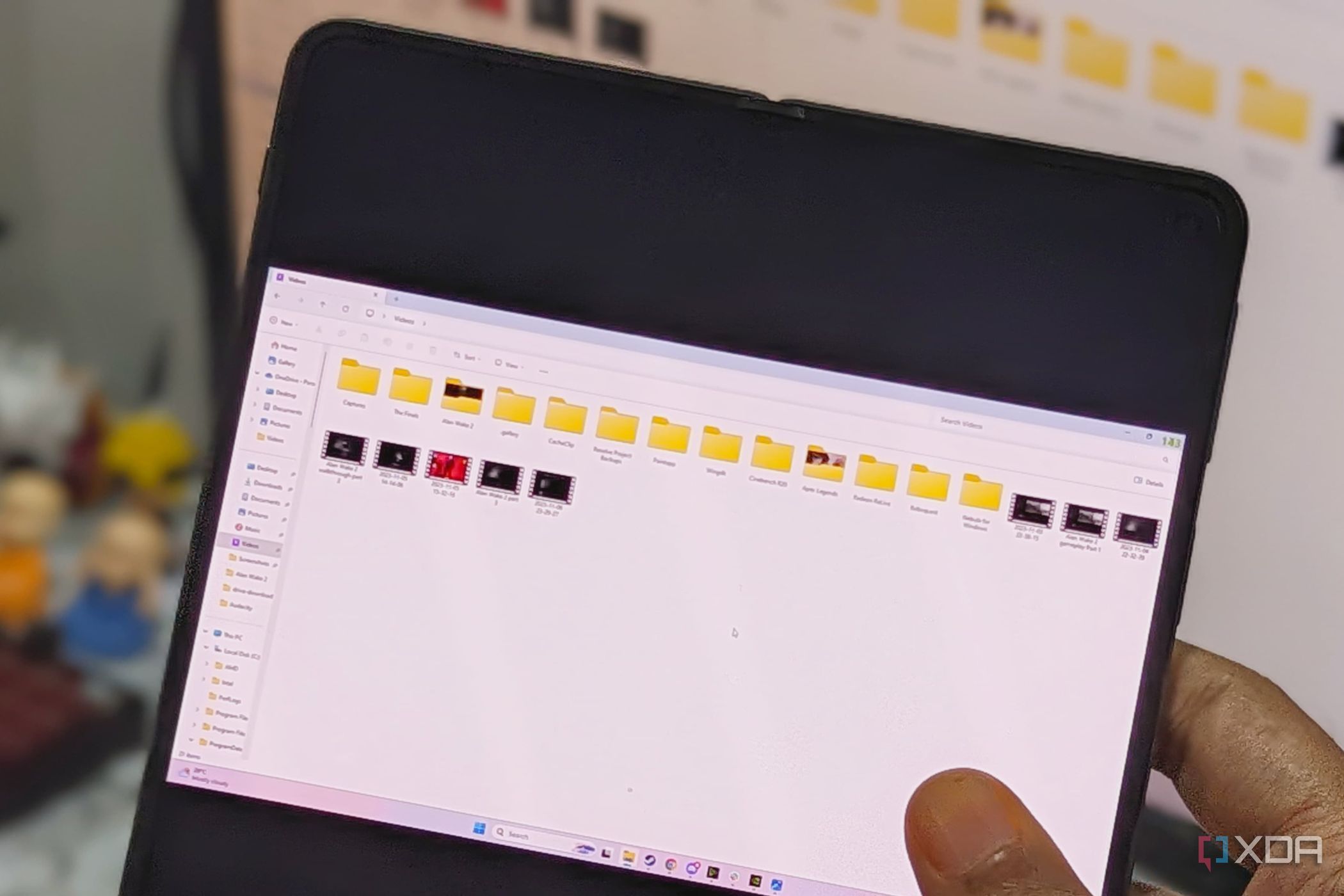 An image showing a person holding a phone displaying file explorer on Moonlight app.
