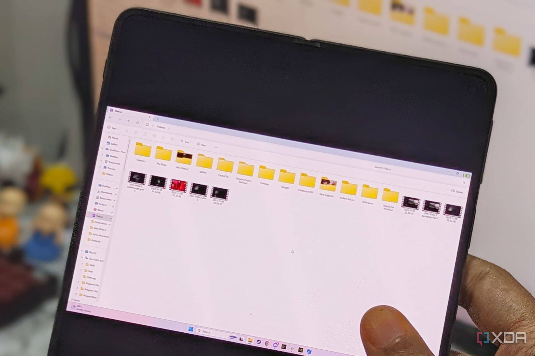 An image showing a person holding a phone displaying file explorer on Moonlight app.