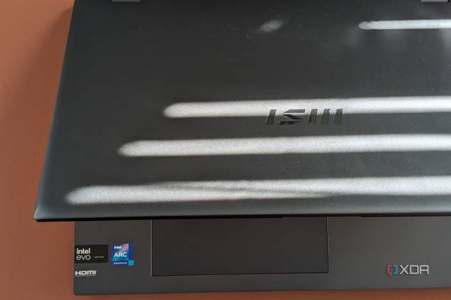 A photo of the MSI Prestige Evo 16 AI lid open with the MSI branding and Intel branding stickers showing