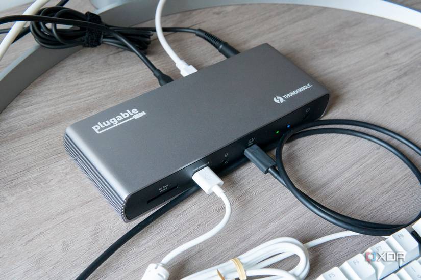 Angled overhead view of the Plugable TBT4-UDX1 docking station with mutliple peripherals connected